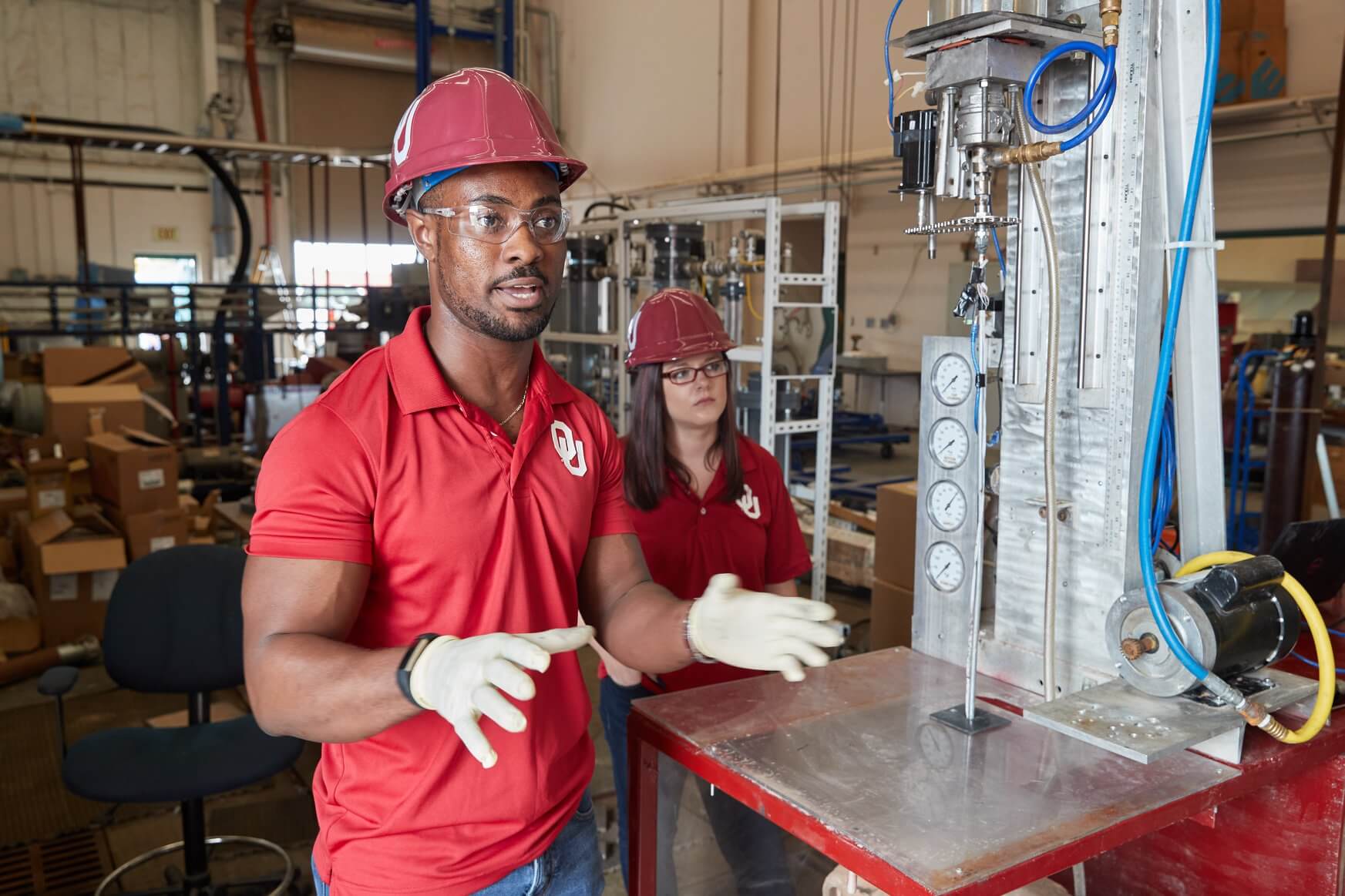 photo of two OU students in a machine shop
